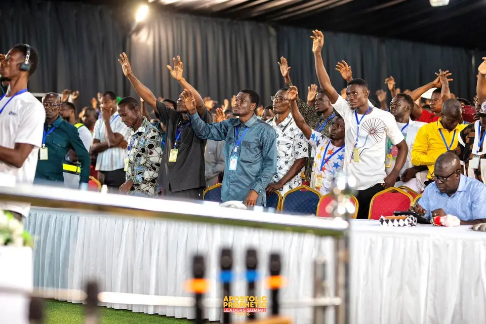 Delegates worshipping with raised hands at APLS 2026